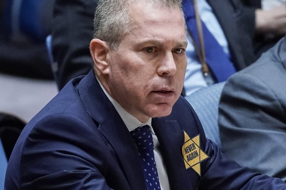 Israel’s U.N. Ambassador Gilad Erdan wears a yellow Star of David that reads &quot;Never Again&quot; in honor of those killed in the unprecedented attack by Hamas, which triggered an ongoing war, as h ...