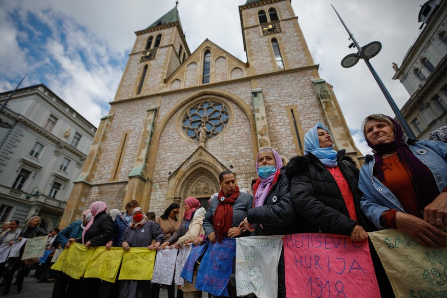SARAJEVO, BOSNIA AND HERZEGOVINA - APRIL 11: Women from Srebrenica attend a peaceful demonstration in front of the 'Heart of Jesus' Cathedral and a statue depicting Pope John Paul II, in memory of 11  ...