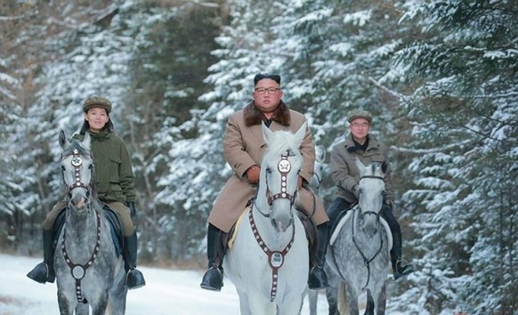 October 16, 2019, Mount Paektu, North Korea: KIM JONG UN on a horse rides on Mount Paektu in a photo released from the on October 16, 2019. Kim is accompanied by senior party officials, including his  ...