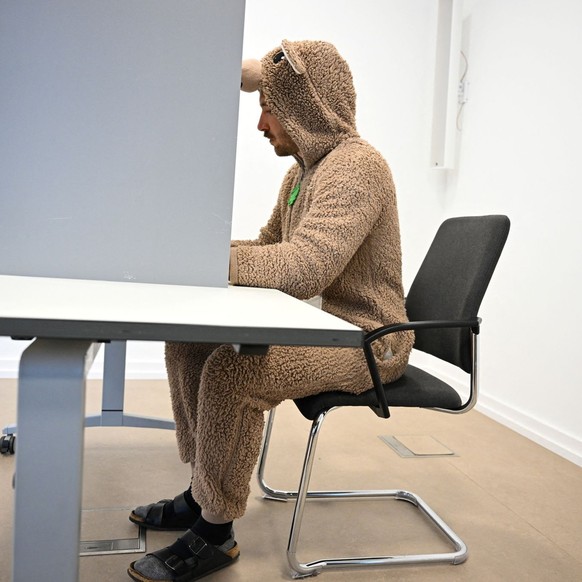 A man wearing a carnival costume votes during the 2025 general election, in Cologne, Germany, February 23, 2025. REUTERS/Jana Rodenbusch