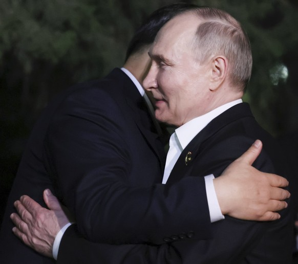 Chinese President Xi Jinping, left, and Russian President Vladimir Putin embrace each other after an informal meeting in Beijing, China, on Thursday, May 16, 2024. (Mikhail Metzel, Sputnik, Kremlin Po ...