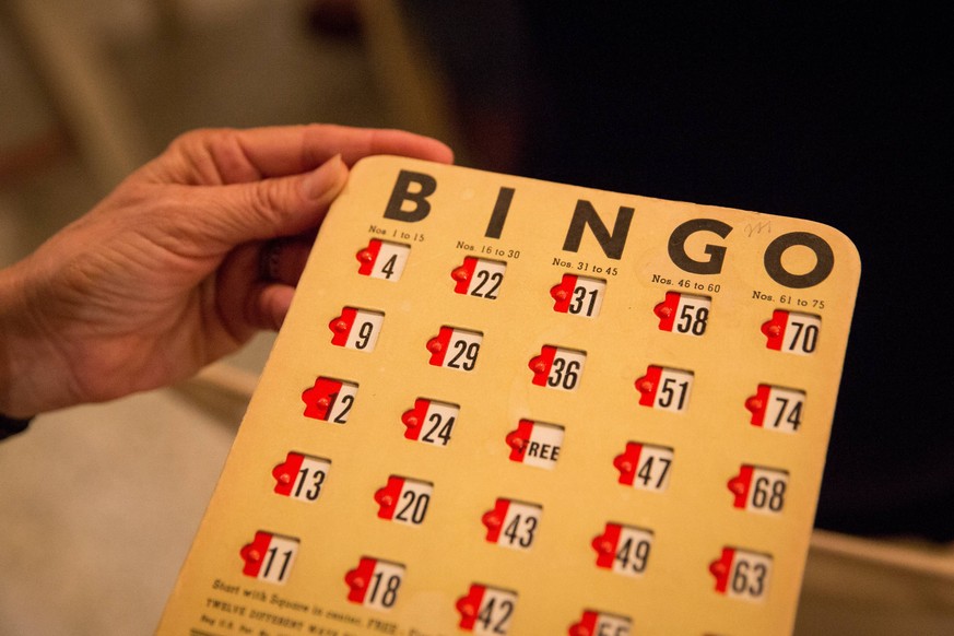 December 28, 2017 - Florida, U.S. - LOREN ELLIOTT Times.Jan Miller holds up an antique bingo card at her home in St. Petersburg on Thursday, Dec. 28, 2017. The bingo night is an annual tradition and p ...