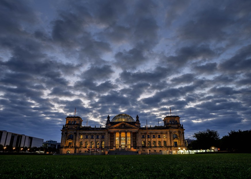 Clouds drift over the Reichstag building with the German parliament in Berlin, Germany, Sunday, Sept. 26, 2021. German elections are held on Sunday. (AP Photo/Michael Probst)