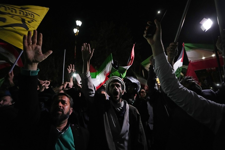 Iranian demonstrators chant slogans during an anti-Israeli gathering in front of the British Embassy in Tehran, Iran, early Sunday, April 14, 2024. Iran launched its first direct military attack again ...