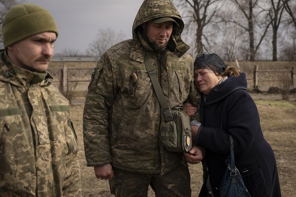 Tetiana Hurieieva, the mother of Volodymyr Hurieiev, a Ukrainian soldier killed in the Bakhmut area, cries after his the funeral in Boryspil, Ukraine, Saturday, March 4, 2023. Pressure from Russian fo ...