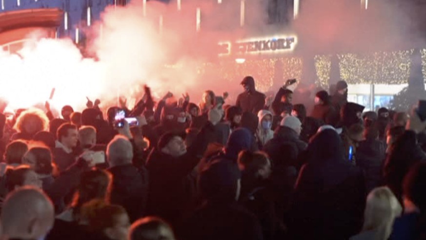 In this image taken from video, demonstrators protest against government restrictions due to the coronavirus pandemic, Friday, Nov. 19, 2021, in Rotterdam, Netherlands. Police fired warning shots, inj ...