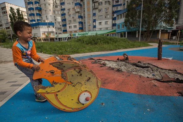 Yuri, a 4-year-old Ukrainian boy, plays in a playground partially destroyed by Russian bombing in Kharkiv, Ukraine, 1 June 2022. During the children s day commemoration in Ukraine, the Attorney office ...