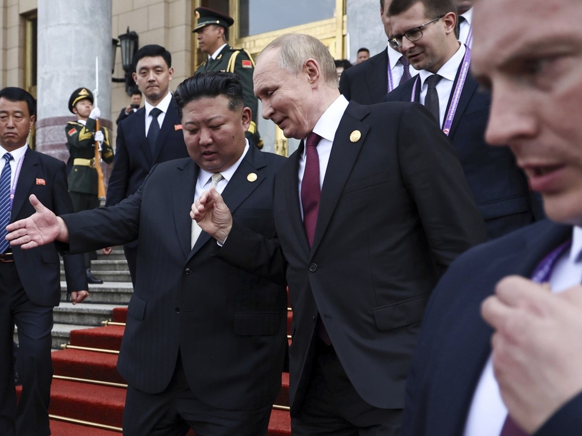 Russian President Vladimir Putin, second right, and North Korean leader Kim Jong Un gesture as they leave a reception following a military parade to commemorate the 80th anniversary of the end of Worl ...