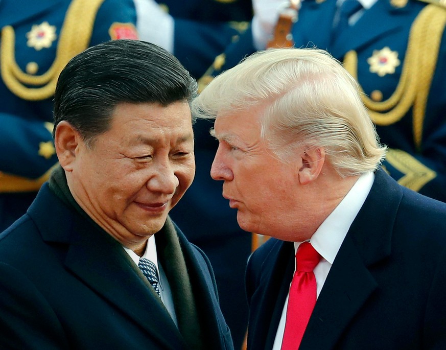 FILE - In this Nov. 9, 2017, file photo, U.S. President Donald Trump, right, chats with Chinese President Xi Jinping during a welcome ceremony at the Great Hall of the People in Beijing. Critics fear  ...