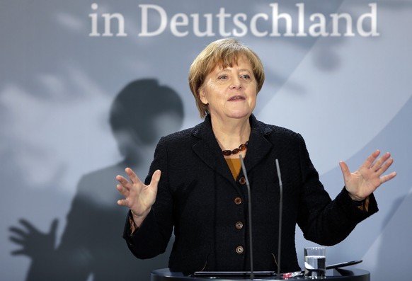 FILE - German Chancellor Angela Merkel delivers a speech during a reception at the chancellery in Berlin, Germany, Monday, Dec. 7, 2015, to mark the 60th. anniversary of the arrival of the first migra ...