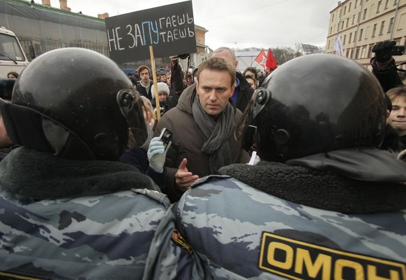 FILE - Opposition leader Alexey Navalny, speaks with riot police officers blocking the way during a protest rally against Prime Minister Vladimir Putin&#039;s rule in St. Petersburg, Russia, on Feb. 2 ...