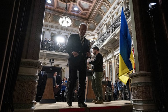 President Joe Biden and Ukrainian President Volodymyr Zelenskyy depart a news conference in the Indian Treaty Room in the Eisenhower Executive Office Building on the White House Campus, Tuesday, Dec.  ...
