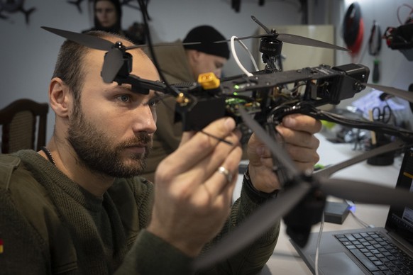 A soldier of Ukraine&#039;s 57th motorised brigade inspects a FPV drone near front line in the Kharkiv region, Ukraine, Thursday, Nov. 7, 2024. (AP Photo/Efrem Lukatsky)