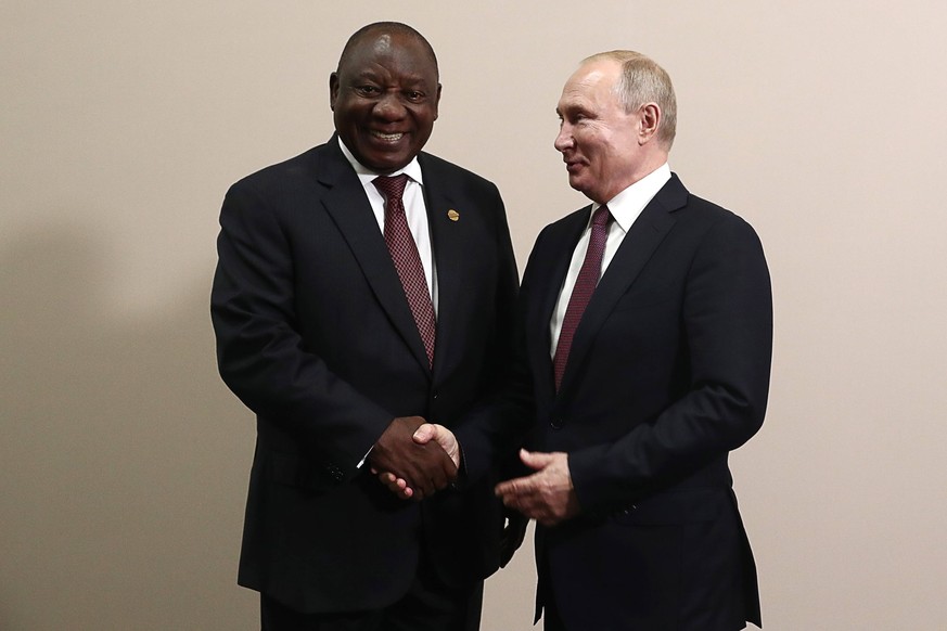SOCHI, RUSSIA - OCTOBER 23, 2019: South Africas President Cyril Ramaphosa L and Russia s President Vladimir Putin shake hands during a meeting on the sidelines of the 2019 Russia-Africa Summit at the  ...