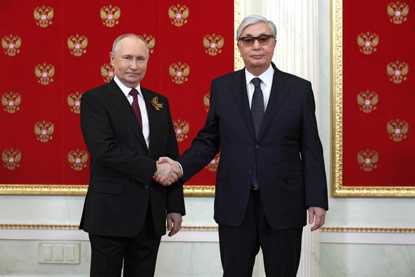 Russian President Vladimir Putin, left, and Kazakhstan&#039;s President Kassym-Jomart Tokayev shake hands at their meeting during the 78th anniversary of the end of World War II celebrations in Moscow ...