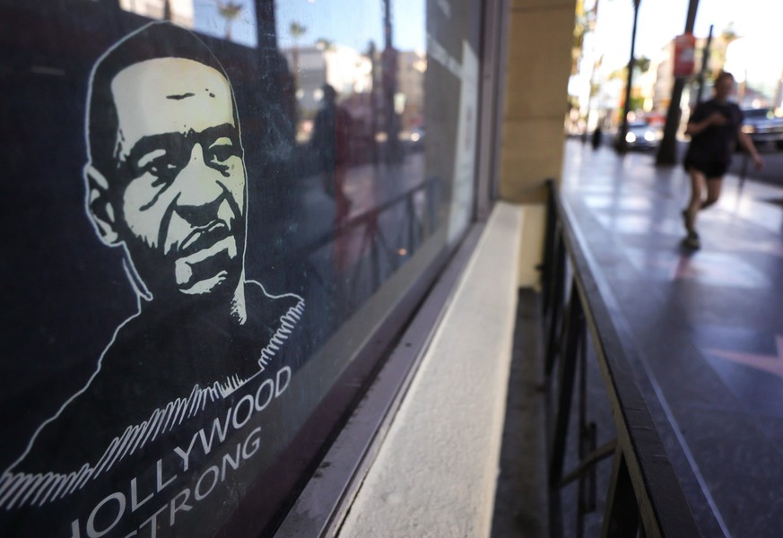 LOS ANGELES, CALIFORNIA - JANUARY 20: A poster depicting George Floyd is displayed on Hollywood Boulevard on January 20, 2021 in Los Angeles, California. During today&#039;s inauguration ceremony Joe  ...