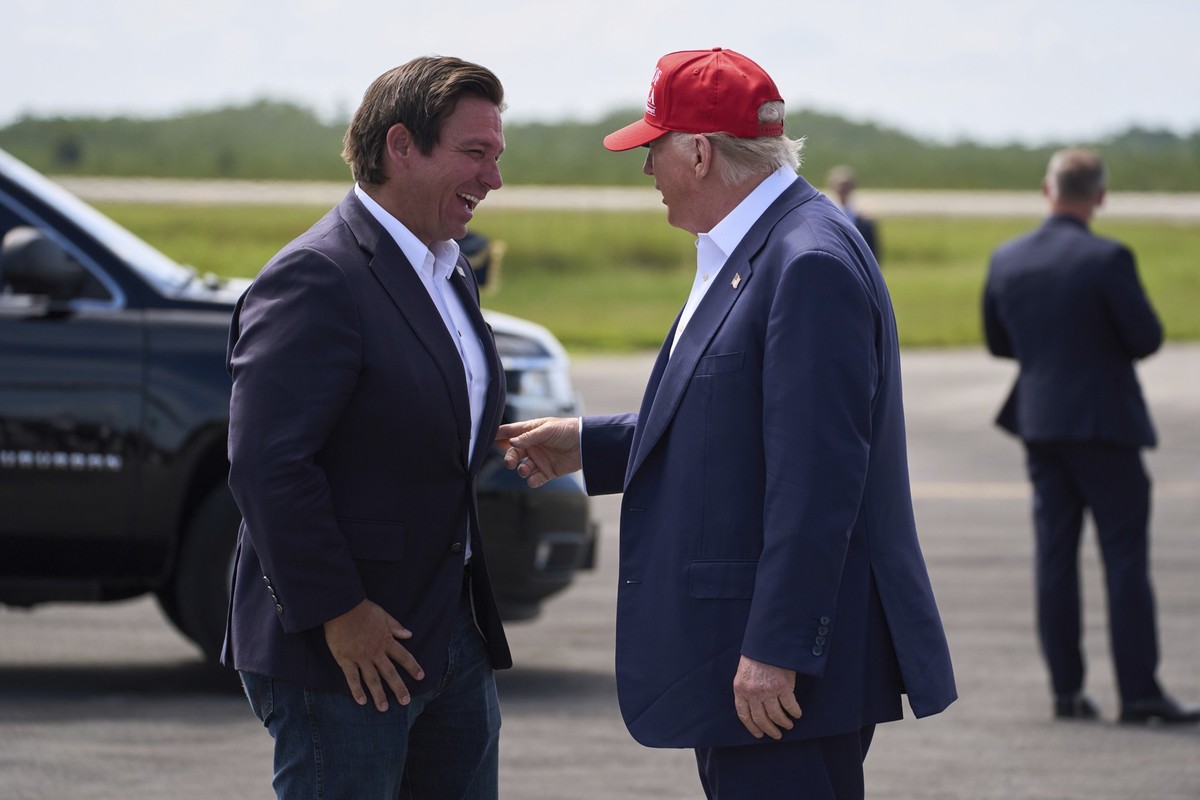President Donald Trump is greeted by Gov. Ron DeSantis, R-Fla., after arriving at Dade-Collier Training and Transition Airport, Tuesday, July 1, 2025, in Ochopee, Fla. (AP Photo/Evan Vucci)