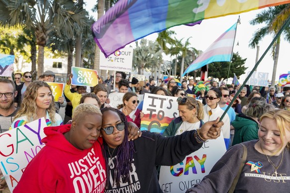 FILE - Florida House Representative Michele Rayner, left, hugs her spouse, Bianca Goolsby, during a march at City Hall in St. Petersburg, Fla., Saturday, March 12, 2022, to protest the controversial & ...