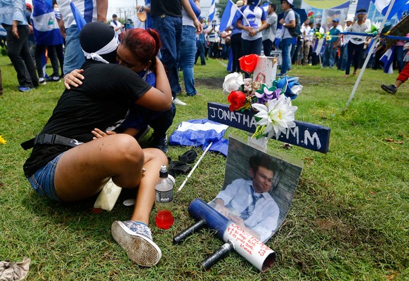 Demonstrators embrace near a memorial for university student Jonathan Morales during a march called "Together we are a volcano" against Nicaragua's President Daniel Ortega's government, in M ...