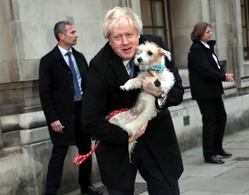 British Prime Minister Boris Johnson and his dog Dilyn leave a Westminster polling station after casting his vote on Thursday, December 12, 2019. Mr Johnson is seeking a majority in the General Electi ...