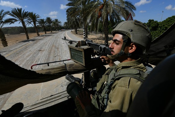 231014 -- SDEROT, Oct. 14, 2023 -- This photo taken on Oct. 13, 2023 shows an Israeli soldier riding an armored vehicle deployed near the Israel-Gaza border, in southern Israel. The Israel Defense For ...