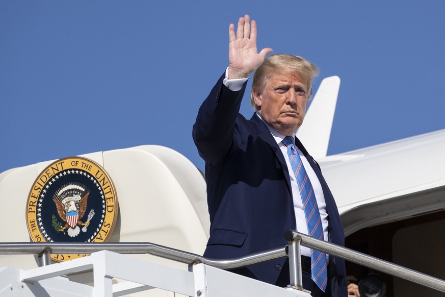 President Donald Trump waves as he boards Air Force One at Morristown Municipal Airport, Sunday, June 14, 2020, in Morristown, N.J. Trump is returning to Washington. (AP Photo/Alex Brandon)