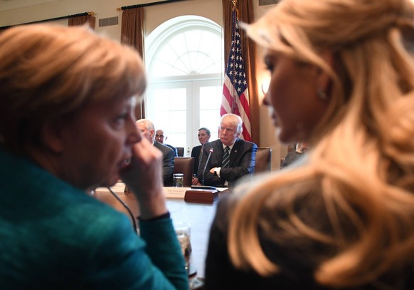 March 17, 2017 - Washington, District of Columbia, United States of America - German Chancellor Angela Merkel L, and Ivanka Trump lR, wisper during a roundtable discussion on vocational training with  ...