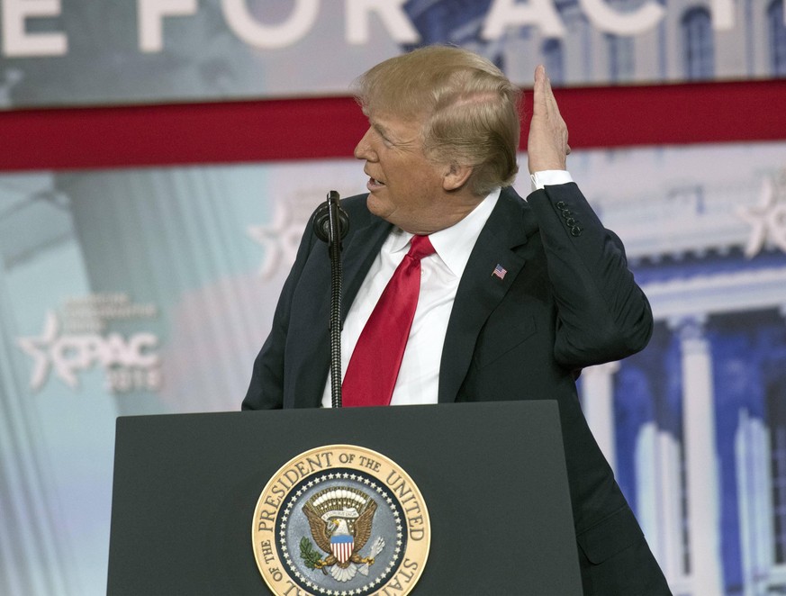 United States President Donald J. Trump adjusts his hair as he speaks at the Conservative Political Action Conference (CPAC) at the Gaylord National Resort and Convention Center in National Harbor, Ma ...