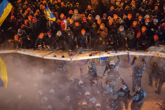 Polizeieinheiten der Sondereinheit Berkut versuchen im Dezember 2013 auf dem Unabhängigkeitsplatz in Kiew die Barrikaden eines Protestcamps der Bewegung "Euromaidan" einzureißen.