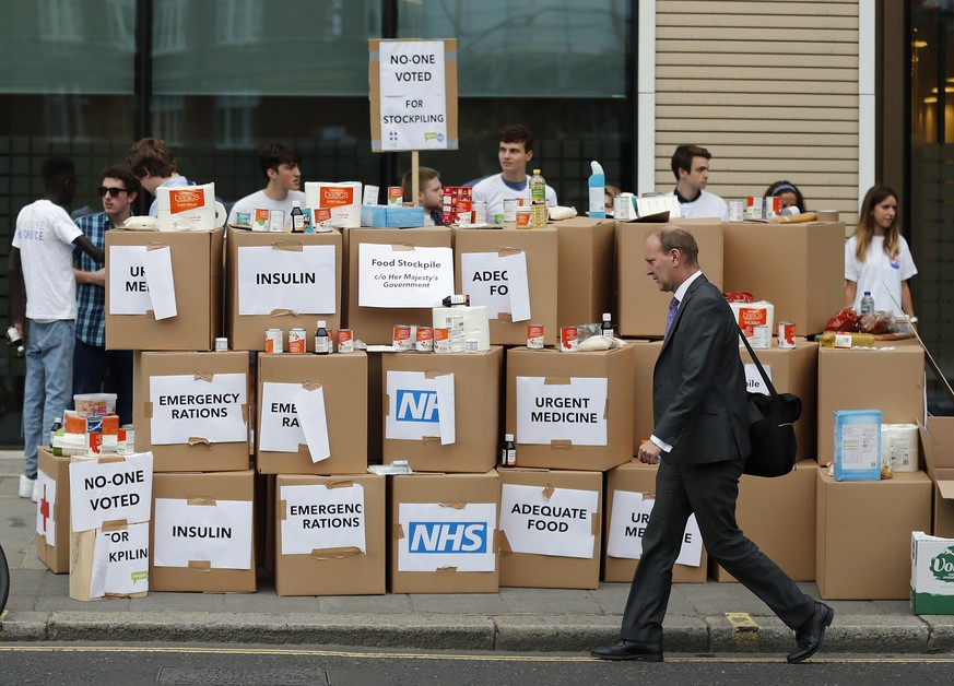 Anti Brexit activists protest as they deliver a pile of medical supplies in cardboard boxes to the Department of Health and Social Care in London, Wednesday, Aug. 22, 2018. Our Future, Our Choice (OFO ...