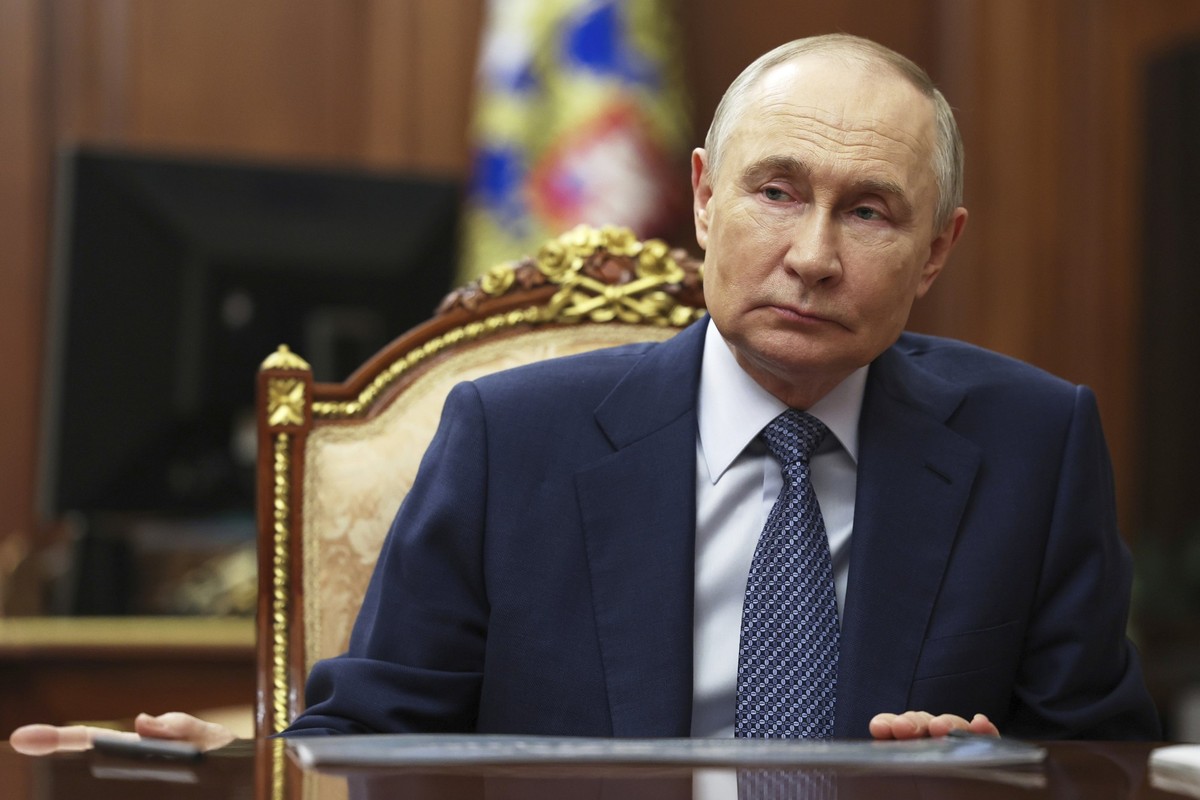 Russian President Vladimir Putin speaks with Sberbank CEO German Gref during their meeting at the Kremlin in Moscow, Russia, Tuesday, July 29, 2025. (Mikhail Metzel, Sputnik, Kremlin Pool Photo via AP ...