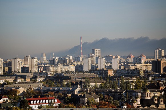 Russians launch missile attack on energy supply facility in Kyiv KYIV, UKRAINE - OCTOBER 11, 2022 - Smoke rises over the site of a missile attack by the russian troops on the CHP in Desnianskyi distri ...