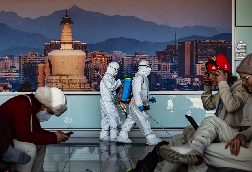 Workers in protective suits against COVID-19 at the Beijing airport during the 2022 Winter Olympics, China, February 21, 2022. (CTK Photo/Roman Vondrous)