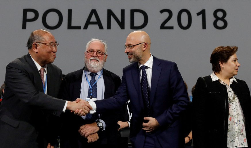 COP24 President Michal Kurtyka shakes hands with the head of Chinese delegation Xie Zhenhua, next to Miguel Canete, EU Comissioner and Executive Secretary of the UN Framework Convention on Climate Cha ...