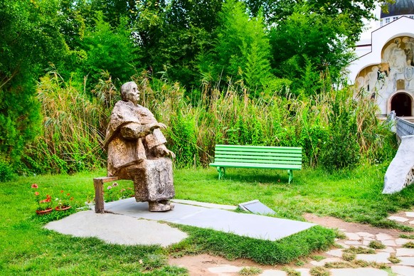 Rupite, Bulgaria - September, 4 2014: Famous bulgarian prophet and clairvoyant Baba Vanga statue in Rupite village and part of the church xkwx baba, vanga, rupite, bulgaria, vangelia, statue, baba van ...