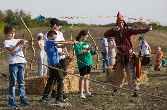 RUSSIA, STAVROPOL - SEPTEMBER 14, 2024: Children shoot bows during the Heritage of Steppes and Mountains historical reenactment festival. Ivan Vysochinsky/TASS PUBLICATIONxINxGERxAUTxONLY 74025292