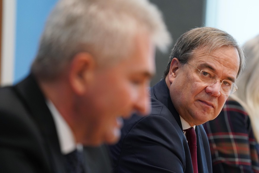 BERLIN, GERMANY - OCTOBER 06: Armin Laschet (R), Governor of the state of North Rhine-Westphalia, and Andreas Pinkwart, Minister of Economy in North Rhine-Westphalia, speak to the media to present mea ...