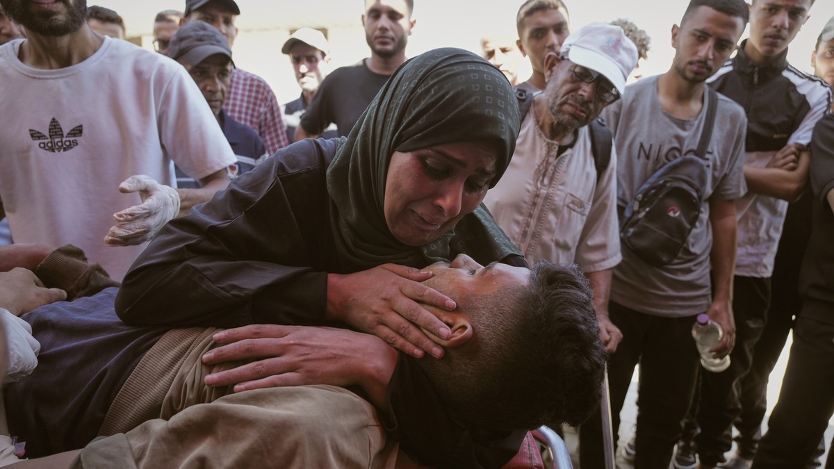 Nabila Al Shaer, center, mourns the body of her son, Jamil Al Shaer, 21, who was killed while trying to receive aid from the U.S.-backed Gaza Humanitarian Foundation (GHF) in Netzarim, in the central  ...
