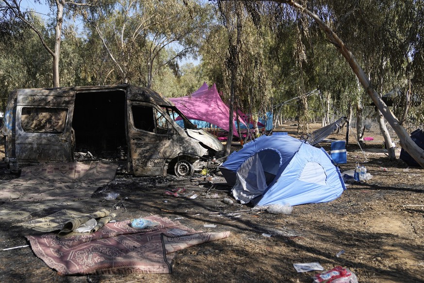 Tents, debris and a burned out van are scattered about the site of a music festival near the border with the Gaza Strip in southern Israel on Thursday, Oct. 12, 2023. At least 260 Israeli festival-goe ...