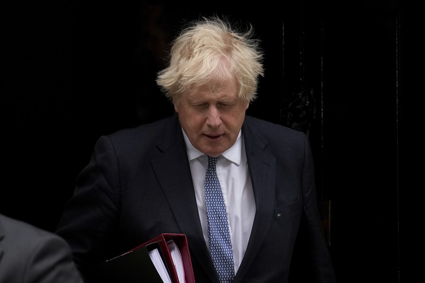 FILE - British Prime Minister Boris Johnson leaves 10 Downing Street to attend the weekly Prime Minister's Questions at the Houses of Parliament, in London, Wednesday, May 25, 2022. Britain’s governin ...