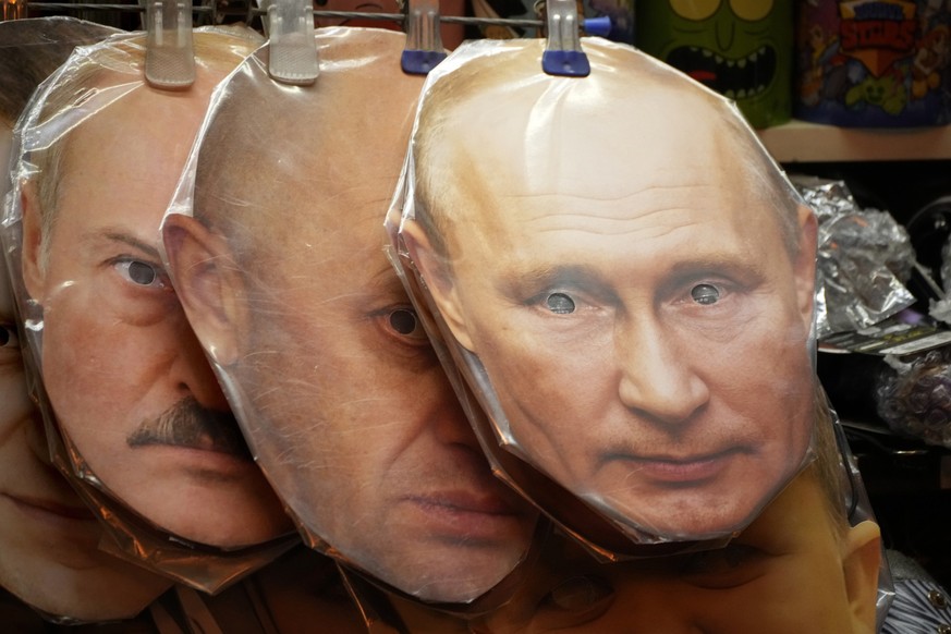 Face masks depicting Russian President Vladimir Putin, right, owner of private military company Wagner Group Yevgeny Prigozhin, centre, and Belarusian President Alexander Lukashenko are displayed amon ...