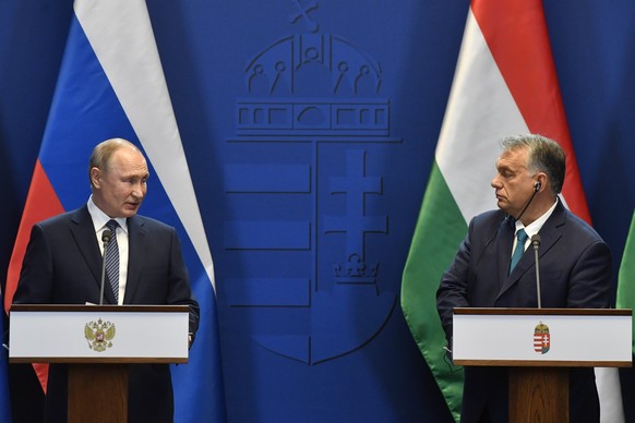FILE - Hungarian Prime Minister Viktor Orban, right, and Russian President Vladimir Putin hold a joint press conference following their talks in Budapest, Hungary, Wednesday, Oct. 30, 2019. After Russ ...