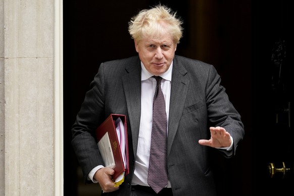 FILE - In this Sept. 15, 2021, file photo, Britain's Prime Minister Boris Johnson leaves 10 Downing Street as he makes his way to Parliament to attend the weekly Prime Minister Questions session, in L ...