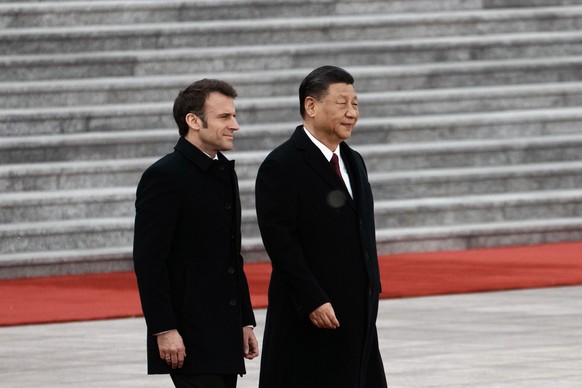 Chinese President Xi Jinping, right, and France&#039;s President Emmanuel Macron attend a welcome ceremony at the Great Hall of the People in Beijing, China, Thursday, April 6, 2023. (AP Photo/Thibaul ...