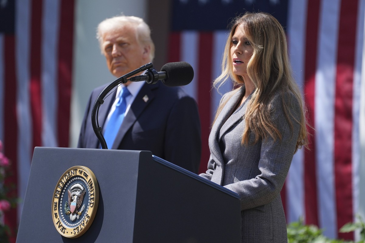 First lady Melania Trump speaks President Donald Trump listens during a bill signing event for the "Take it Down Act" in the Rose Garden of the White House, Monday, May 19, 2025, in Washingt ...