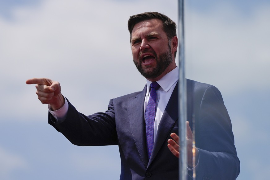 Republican vice presidential nominee Sen. JD Vance, R-Ohio, gestures to supporters during a campaign rally at North Carolina Aviation Museum, Wednesday, Aug. 21, 2024, in Asheboro, N.C. (AP Photo/Juli ...