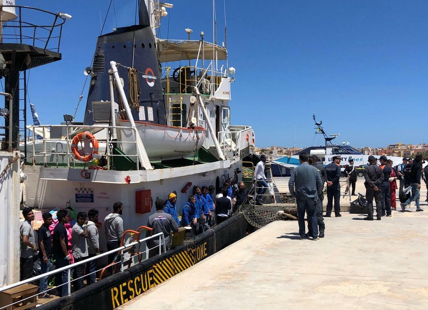 Rescued migrants desembark from the Mare Jonio rescue ship of the Italian NGO Mediterranea Saving Humans as it docked at the port of the Italian island of Lampedusa, southern Italy, Friday, May 10, 20 ...