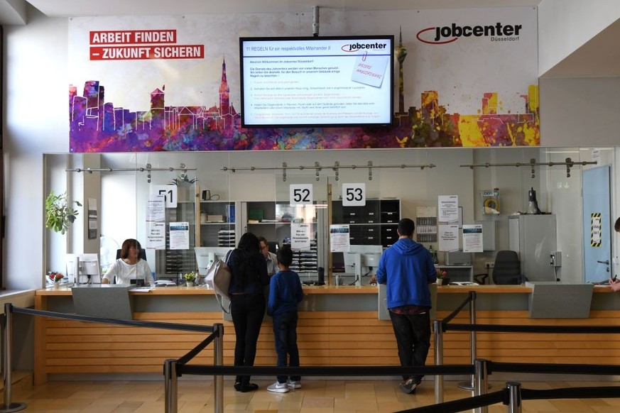 People visit a Jobcenter in Duesseldorf-Mitte, western Germany, on August 25, 2017.
The number of people out of work has halved in Germany since 2005, but a core of around 900,000 who have been lookin ...