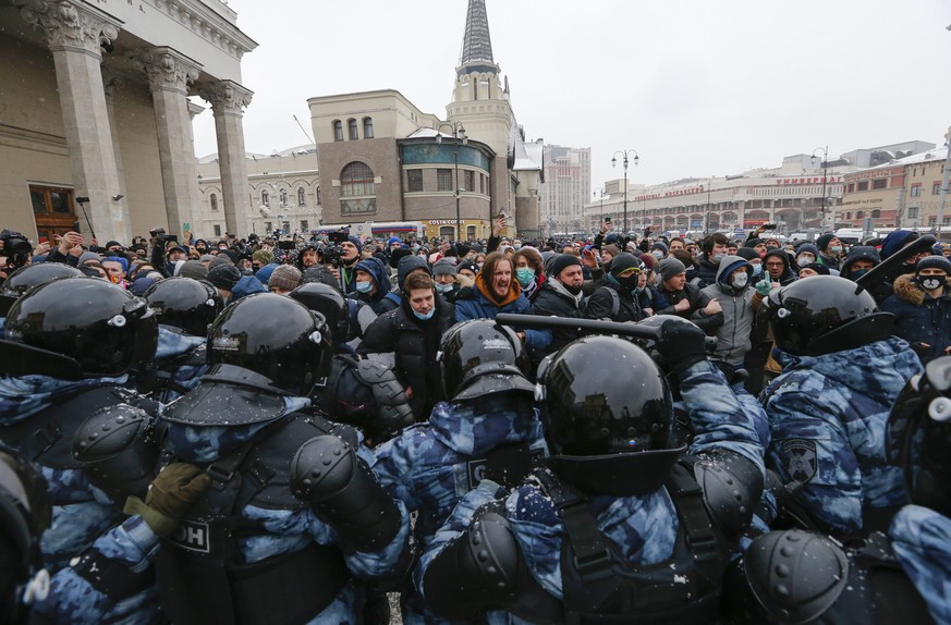 People clash with police during a protest against the jailing of opposition leader Alexei Navalny in Moscow, Russia, Sunday, Jan. 31, 2021. Thousands of people took to the streets Sunday across the co ...