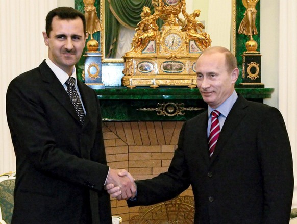 Russian President Vladimir Putin shakes hands with his Syrian counterpart Bashar al-Asad (R) during their meeting in the Kremlin Moscow, Tuesday 19 December 2006. EPA/PRESIDENTIAL PRESS SERVICE/ITAR-T ...